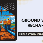 Groundwater recharge structure with water percolating into the soil through recharge pit in a rural setting
